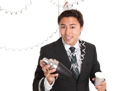 Party guy with cocktail shaker and a mug. Wearing a suit and tie, with a party hat. White background.の写真素材