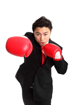 Businessman wearing red boxing gloves and a black suit with a red tie  White background の写真素材