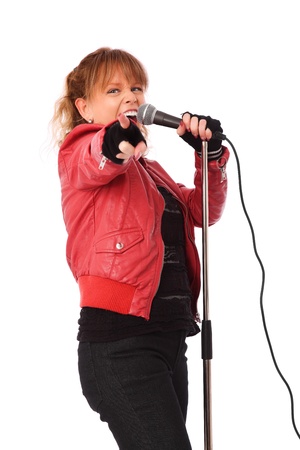 Cool looking rocker chic wearing a red leather jacket, screaming in a microphone  White background の写真素材