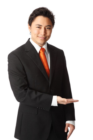 Attractive businessman in a suit and tie, showing  White background の写真素材