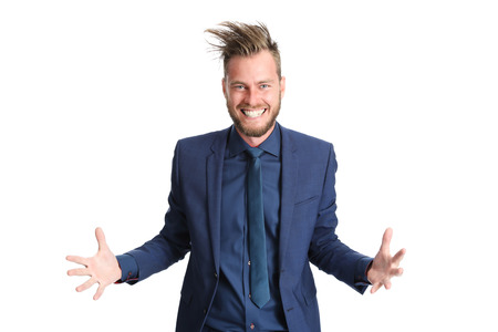 Crazy businessman in a blue suit with crazy hair. Screaming against camera. White background.の写真素材