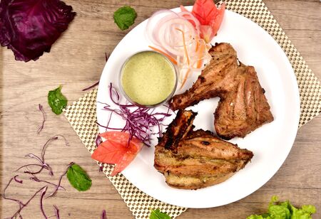 a plate of grilled chickenの写真素材