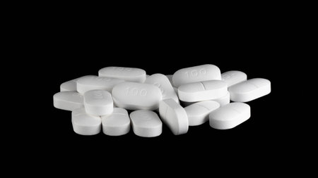 Pile of Sertraline 100mg pills on black background. Setraline is an SSRI or anti depressant in treatment for depression and anxiety disordersの写真素材