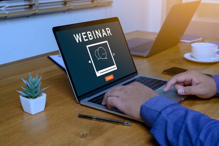 Person using a laptop computer for online training webinars. E-learning browsing connection and cloud online technology webcast concept. Laptop mockup with clipping path on screen.の写真素材