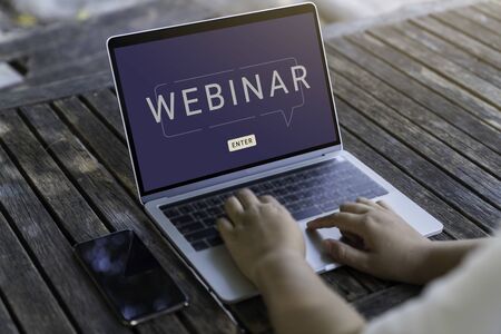 Person using a laptop computer for online training webinars. E-learning browsing connection and cloud online technology webcast concept. Laptop mockupの写真素材