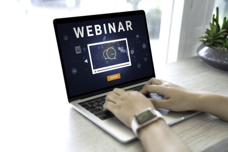 Person using a laptop computer for online training webinars. E-learning browsing connection and cloud online technology webcast concept. Laptop mockupの写真素材