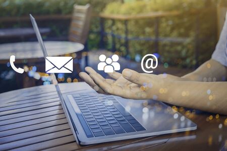 Contact us or Customer support hotline people connect. Businessman using a mobile phone with the (email, call phone, mail) icons.の写真素材