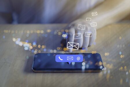 Contact us or Customer support hotline people connect. Businessman using a mobile phone with the (email, call phone, mail) icons.の写真素材