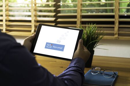 Person using a tablet computer with email communication connection message online and chat on social...
