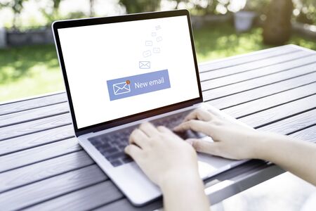 Person using a laptop computer with email communication connection message online and chat on social media with global letters concept. Laptop mockupの写真素材
