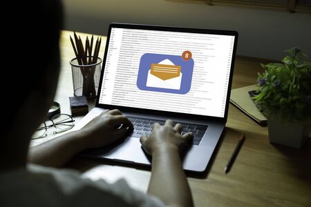 Person using a laptop computer with email communication connection message online and chat on social...