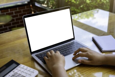 Blank screen laptop computer on wood table. business concept. Mockup with copy space.