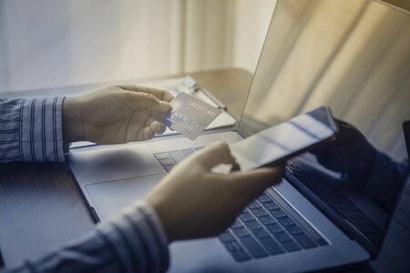 Person using online banking with credit card on touch screen device. Internet online banking. Digital and internet payments shopping on network. All on screen and credit card are designed up.の写真素材