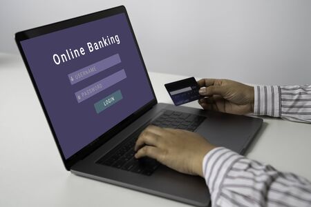 Person using online banking with credit card on touch screen device. Internet online banking. Digital and internet payments shopping on network. All on screen and credit card are designed up.の写真素材