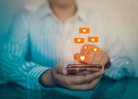 Woman hands using mobile smartphone with social love app for valentine's day.