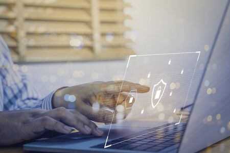 Businessman using a laptop computer with technology cybersecurity and privacy concept. protection and safe data for global network security.の写真素材