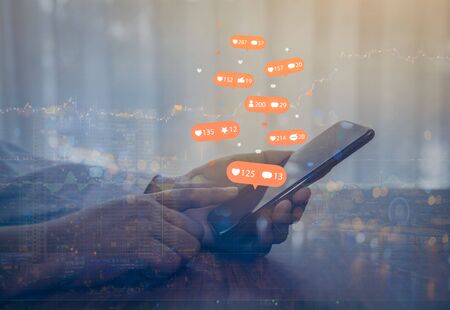 Double exposure of businessman using a social media marketing concept on mobile phone with...