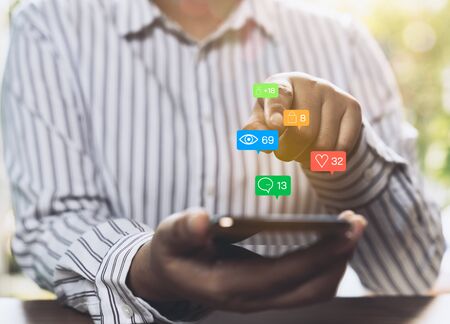Businesswoman using a social media marketing concept on mobile phone with notification icons of...
