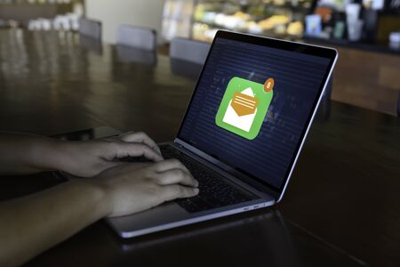Person using a laptop computer with email communication connection message online and chat on social media with global letters concept. Laptop mockupの写真素材