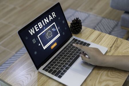 Person using a laptop computer for online training webinars. E-learning browsing connection and cloud online technology webcast concept. Laptop mockupの写真素材