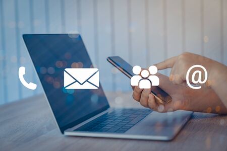 Contact us or Customer support hotline people connect. Businessman using a laptop with the (email,...