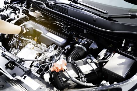 Services car engine machine concept, Car mechanic checking a car engine and car service and maintenance.の写真素材