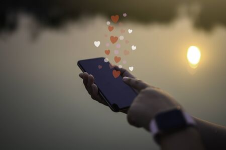 Woman hands using mobile smartphone with social love app for valentine's day.
