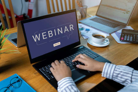 Person using a laptop computer for online training webinars. E-learning browsing connection and...