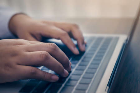 Person using a laptop computer for online training webinar. E-learning browsing connection and cloud...