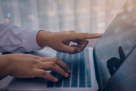 Person using a laptop computer for online training webinar. E-learning browsing connection and cloud online technology webcast concept. Laptop with copy space for webinar text ads.の写真素材