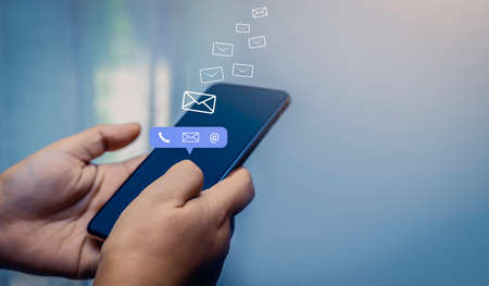 Contact us or Customer support hotline people connect. Businessman using a mobile phone with the...