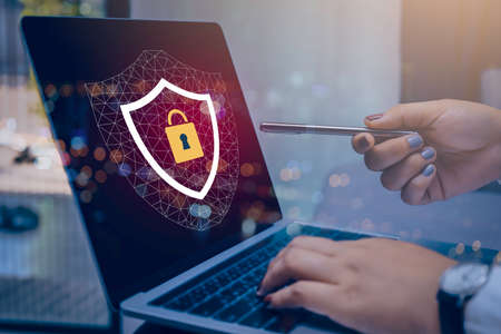 Businesswoman hand using laptop with Data protection, Cyber security secure, information safety and...