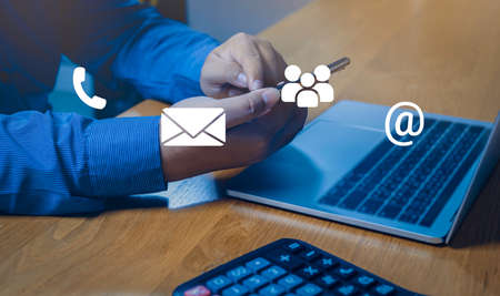 Contact us or Customer support hotline people connect. Businessman using a mobile phone with the...