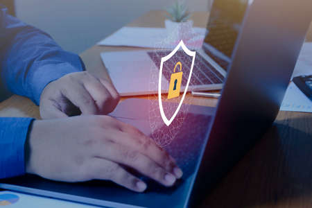 Businessman hand using laptop with Data protection, Cyber security secure, information safety and...