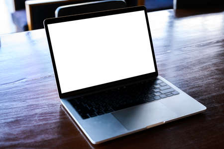 Businesswoman hand using laptop mockup white background on desk. computer with blank screen.の写真素材