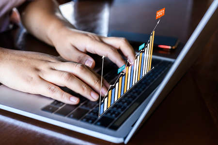 Businessman using a laptop with data analytics and statistics information business technology on...