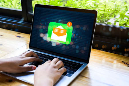 Person using a laptop computer with email communication connection message online and chat on social...