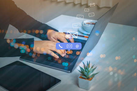 Contact us or Customer support hotline people connect. Businessman using a laptop computer with the...