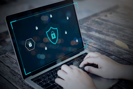 Person using a laptop computer with technology cybersecurity and privacy concept. protection and...