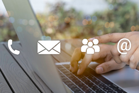 Contact us or Customer support hotline people connect. Business people using a laptop computer with the (email, call phone, mail) icons.の写真素材