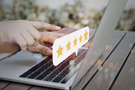 Business people using laptop computer with popup five star icon for feedback review satisfaction...
