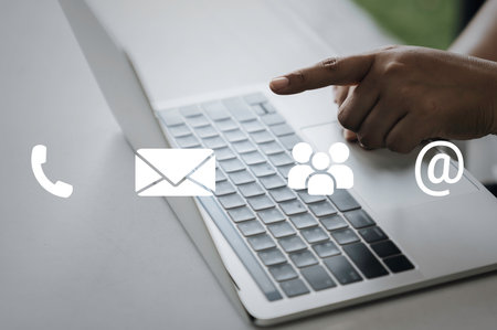 Contact us or Customer support hotline people connect. Business people using a laptop computer with the (email, call phone, mail) icons.の写真素材