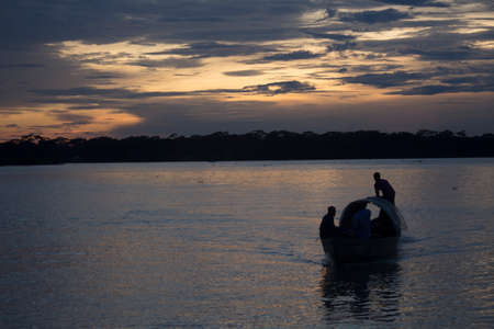 In the evening the people of the village are crossing the river by boat.  The place is Barisal district of Bangladeshのeditorial素材