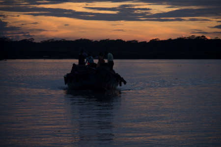 In the evening the people of the village are crossing the river by boat.  The place is Barisal district of Bangladeshのeditorial素材