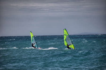 Windsurfers compete in the waves of the Mediterranean Sea.の写真素材