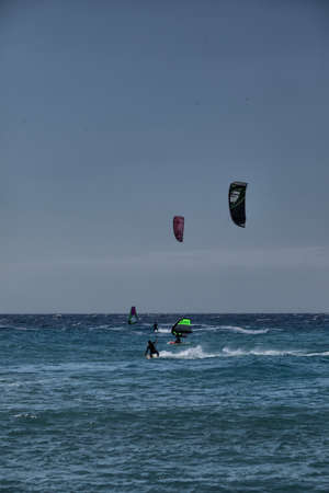 Kitesurfers compete in the waves of the Mediterranean Sea.の写真素材