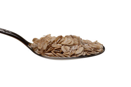 Oatmeal in a spoon isolated over white background