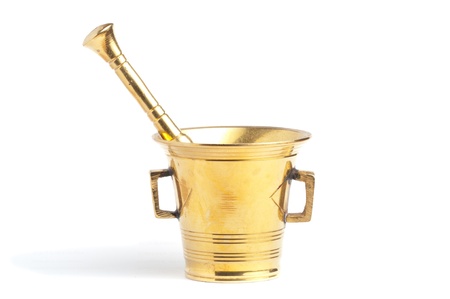 Antique brass mortar and pestle set over white backgroundの写真素材