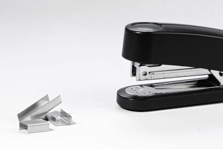 black stapler and staples isolated on white backgroundの写真素材