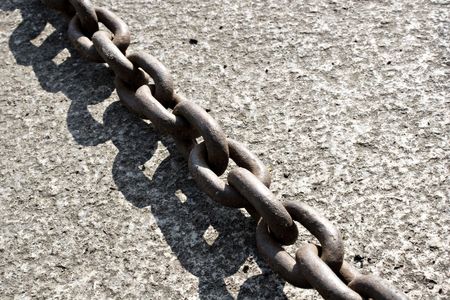 big rusty chain on graniteの写真素材